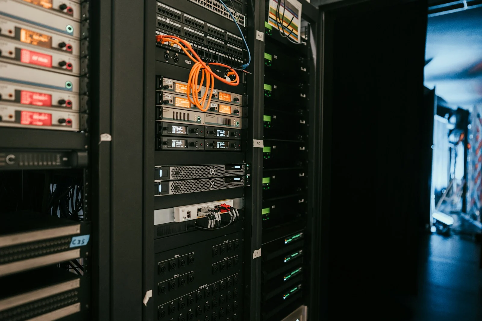 Network and computing equipment in dark racks with orange patch cables